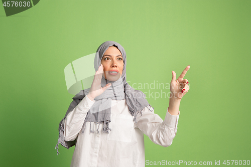 Image of Happy arab woman in hijab. Portrait of smiling girl, posing at studio background