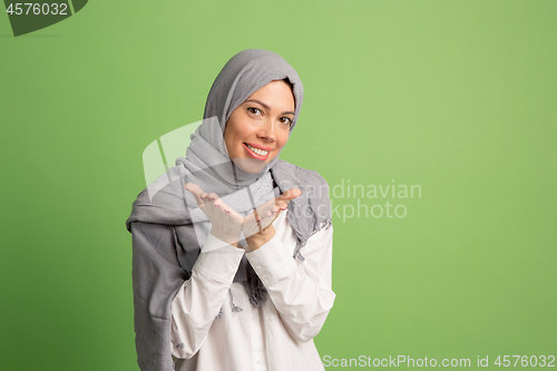 Image of Happy arab woman in hijab. Portrait of smiling girl, posing at studio background