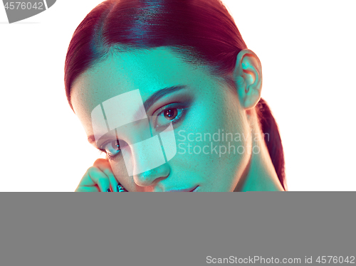 Image of High Fashion model woman in colorful bright lights posing in stu