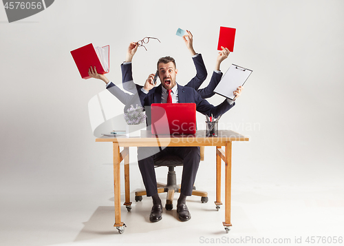 Image of businessman with many hands in elegant suit working with paper, document, contract, folder, business plan.