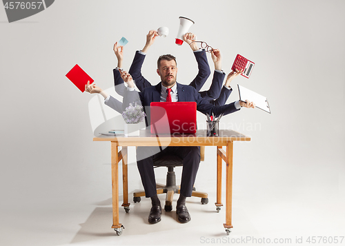 Image of businessman with many hands in elegant suit working with paper, document, contract, folder, business plan.