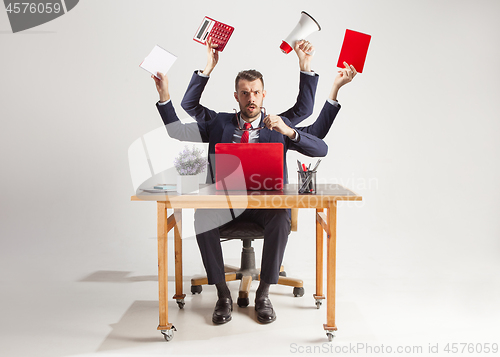 Image of businessman with many hands in elegant suit working with paper, document, contract, folder, business plan.