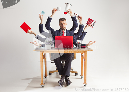 Image of businessman with many hands in elegant suit working with paper, document, contract, folder, business plan.