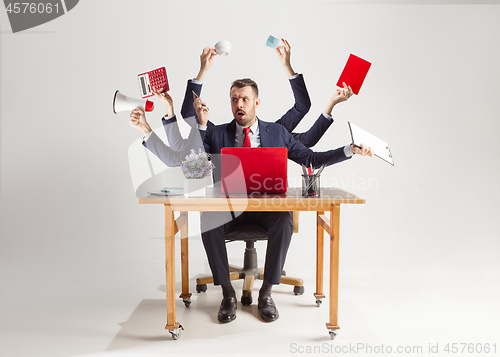 Image of businessman with many hands in elegant suit working with paper, document, contract, folder, business plan.