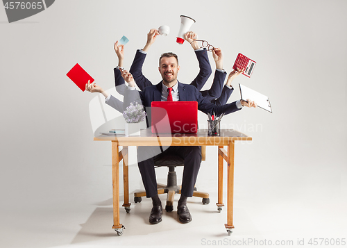 Image of businessman with many hands in elegant suit working with paper, document, contract, folder, business plan.