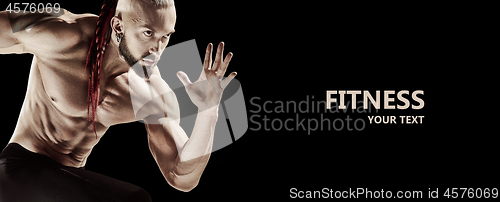 Image of Man doing weight lifting in gym on black background.