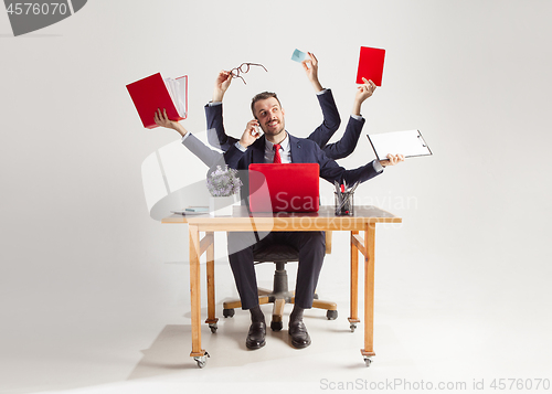 Image of businessman with many hands in elegant suit working with paper, document, contract, folder, business plan.