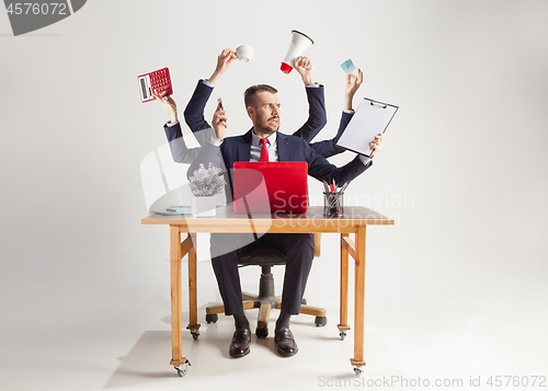 Image of businessman with many hands in elegant suit working with paper, document, contract, folder, business plan.