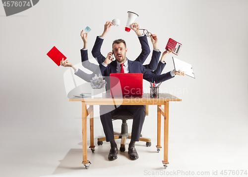 Image of businessman with many hands in elegant suit working with paper, document, contract, folder, business plan.