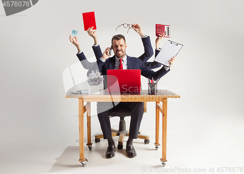 Image of businessman with many hands in elegant suit working with paper, document, contract, folder, business plan.