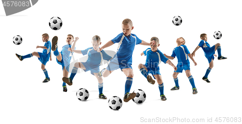 Image of Young boy with soccer ball doing flying kick