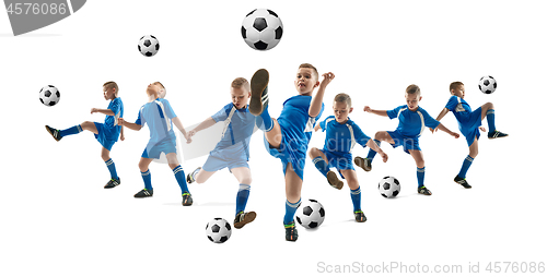 Image of Young boy with soccer ball doing flying kick