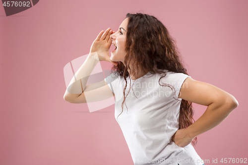 Image of Isolated on pink young casual woman shouting at studio