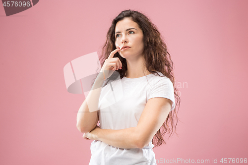 Image of Young serious thoughtful business woman. Doubt concept.