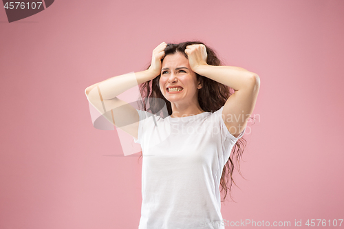 Image of Beautiful woman looking bewildered isolated on pink