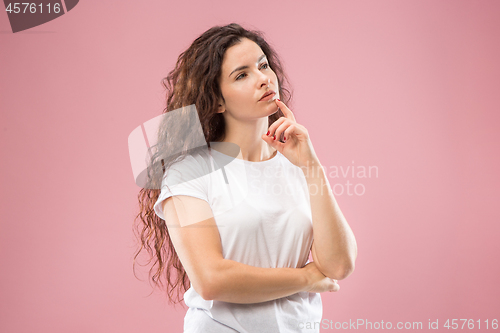 Image of Young serious thoughtful business woman. Doubt concept.