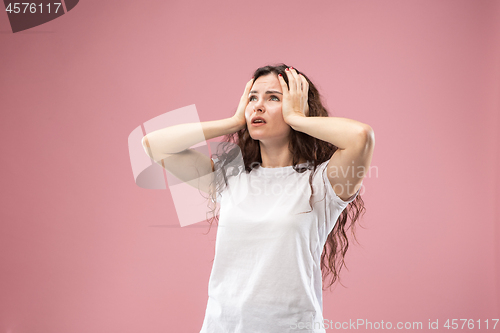 Image of Beautiful woman looking bewildered isolated on pink