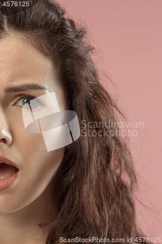 Image of Beautiful woman looking bewildered isolated on pink