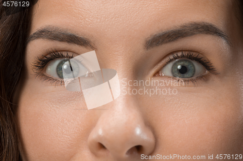 Image of Beautiful woman looking suprised isolated on pink