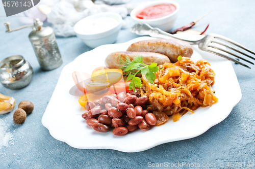 Image of sausages with fried cabbage