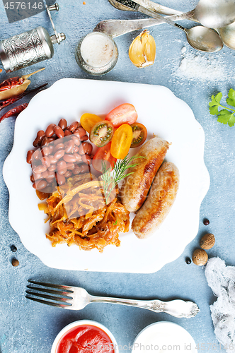 Image of sausages with fried cabbage