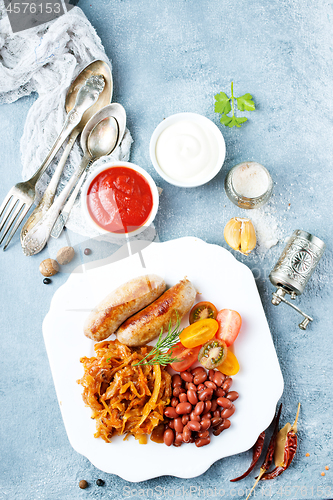 Image of sausages with fried cabbage