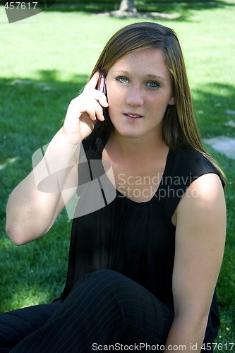 Image of Beautiful Girl in the Park in a Black Dress Talking on the Phone