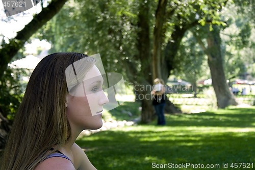 Image of Beautiful Girl in the Park Looking into the Future