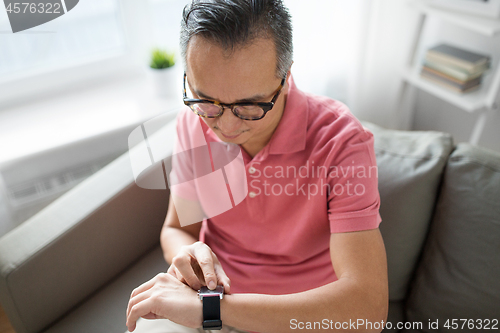 Image of close up of man with smart watch