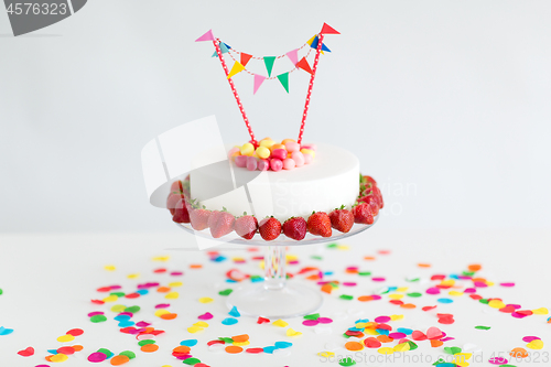 Image of close up of birthday cake with garland on stand