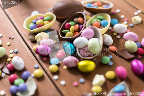 Image of chocolate eggs and candy drops on wooden table