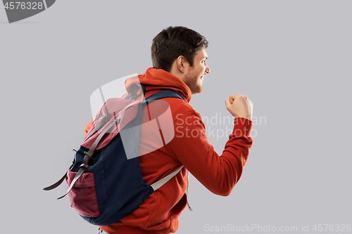Image of male tourist or student celebrating success