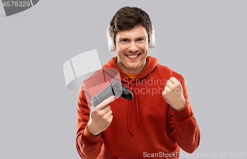 Image of man with gamepad playing video game