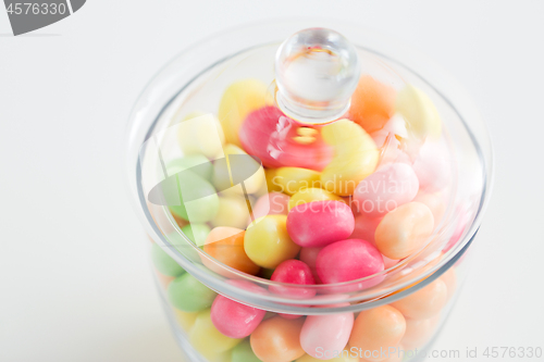 Image of close up of glass jar with colorful candy drops