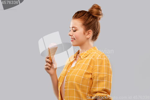 Image of happy red haired teenage girl with ice cream cone