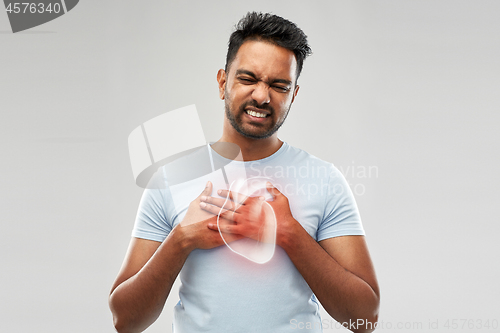 Image of unhappy man having heart attack or heartache