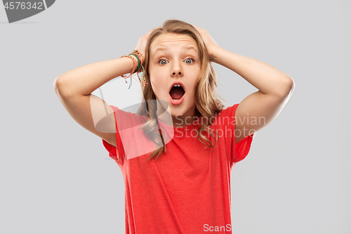 Image of impressed or shocked teenage girl in red t-shirt