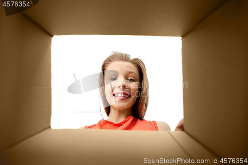 Image of happy surprised girl looking into gift box