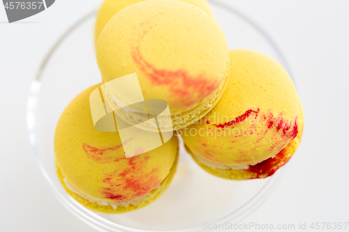 Image of close up of yellow macarons on confectionery stand