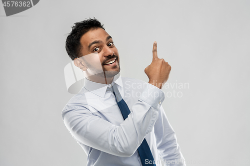 Image of indian businessman pointing finger at something