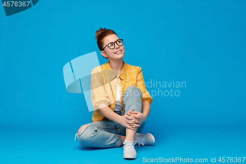 Image of redhead teenage student girl in glasses dreaming