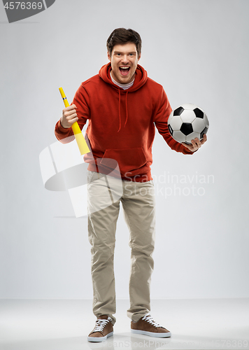 Image of man or football fan with soccer ball and vuvuzela
