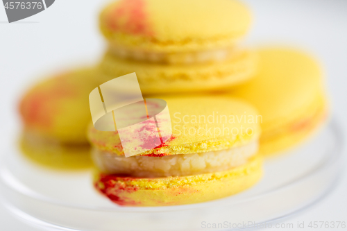 Image of close up of yellow macarons on confectionery stand