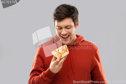 Image of happy young man eating pizza
