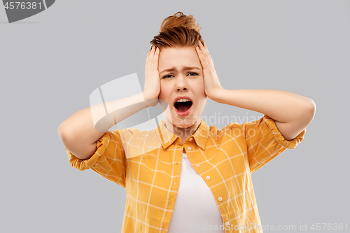 Image of terrified red haired teenage girl screaming