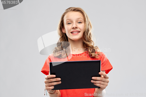 Image of smiling teenage girl with tablet computer