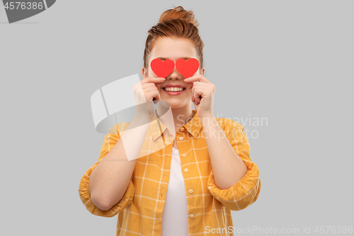 Image of smiling red haired teenage girl with hearts