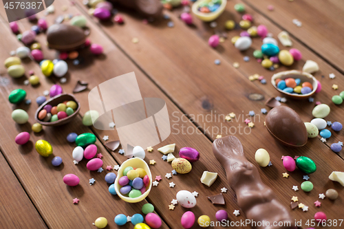 Image of chocolate eggs and candy drops on wooden table