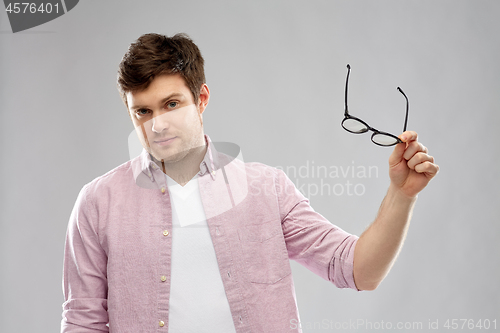 Image of young man with glasses over grey background