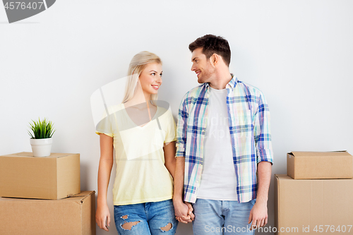 Image of happy couple with boxes moving to new home